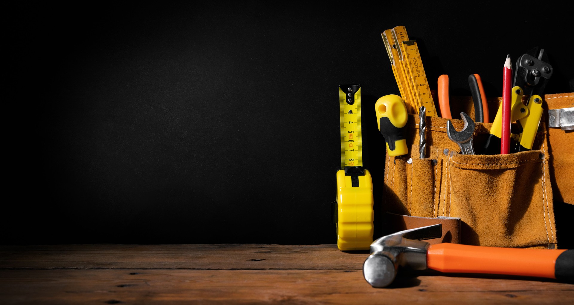 home improvement - construction tools on black background with copy space. banner